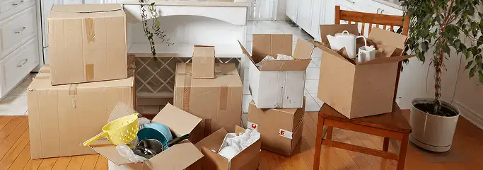 Packed moving boxes and household items in a kitchen before move-out or move-in cleaning, Miami, FL.
